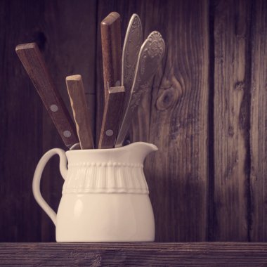 Eski siyah ahşap arka planda beyaz mutfak bulaşık takımı