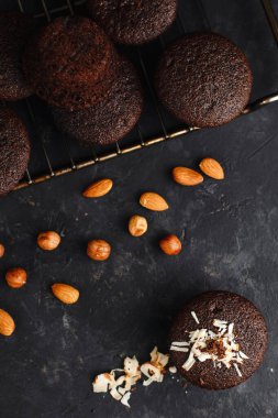 Çikolatalı kekler, muzlu ve fındıklı kekler, siyah bir masa ve koyu bir arka plan. Üst manzara, yan manzara. Yakın plan ve orta plan. Metin için boşluk.