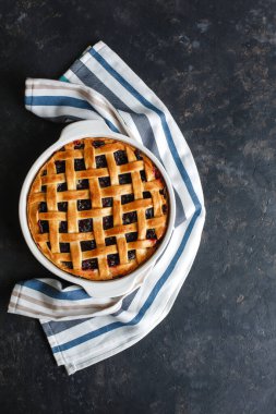 Ev yapımı Amerikan kirazlı turtası. Çok lezzetli. Koyu arkaplanda, üst tarafta, kenar manzaralı. Metin için boşluk.