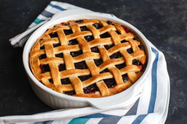 Ev yapımı Amerikan kirazlı turtası. Çok lezzetli. Koyu arkaplanda, üst tarafta, kenar manzaralı. Metin için boşluk.
