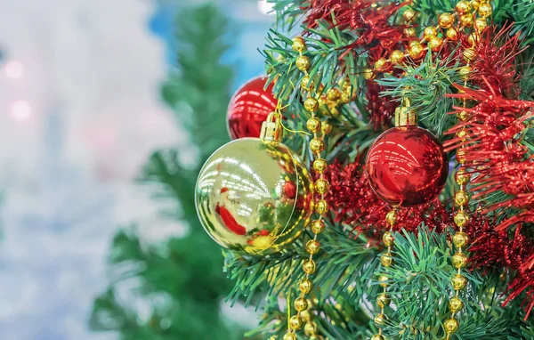 Árvore de Natal com bolas de Natal vermelhas e amarelas, contas e ouropel . — Fotografia de Stock