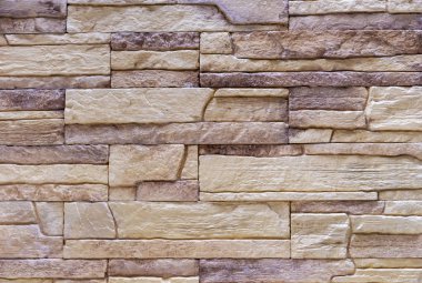 Evin dış dekorasyonu için bej ön cephe taşının dokusu.