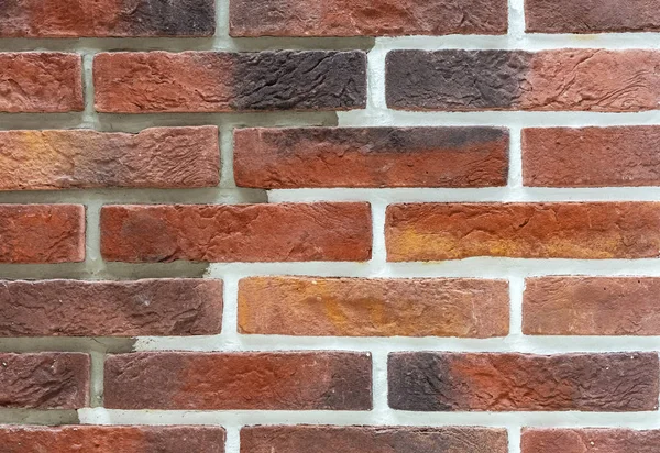 Pared de ladrillo de ladrillos rojos y marrones. Antecedentes y textura del ladrillo . — Foto de Stock