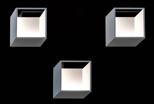 Square LED wall lights on a black background. LED lighting in a modern interior.