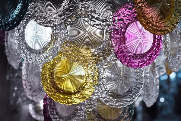 Glass chandelier with round colored plates in the shape of decorative plates. — Stock Photo, Image