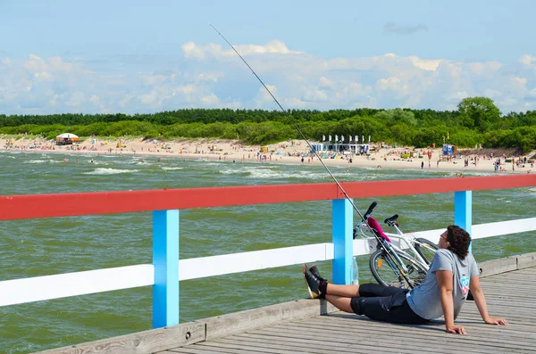 Unbekannter junger Mann fischt von Seebrücke in Palanga, Litauen — Stockfoto