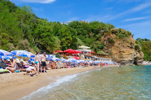 Menschen ruhen sich am Strand mogren 2 in beliebten Urlaubsort Budva, Montenegro — Stockfoto