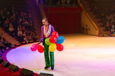 Moscow circus on ice on tour. Clown with balloons on arena clipart