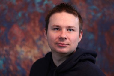 Siyah kapüşonlu genç beyaz bir adam.