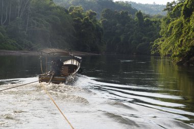Nehri üzerinde tekne yüzen.