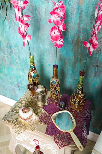 Bottles and flowers on the bedside table. — Stock Photo, Image