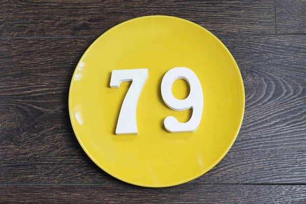 The number seventy-nine on the yellow plate. — Stock Photo, Image
