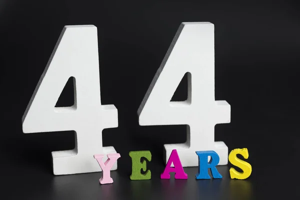 Letters and numbers forty-four years on a black background. — Stock Photo, Image