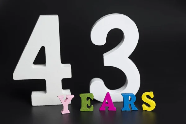 Letters and numbers forty-three years on a black background. — Stock Photo, Image