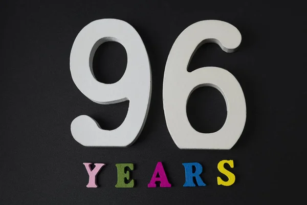Bokstäver och siffror nittiosex år på svart bakgrund. — Stockfoto