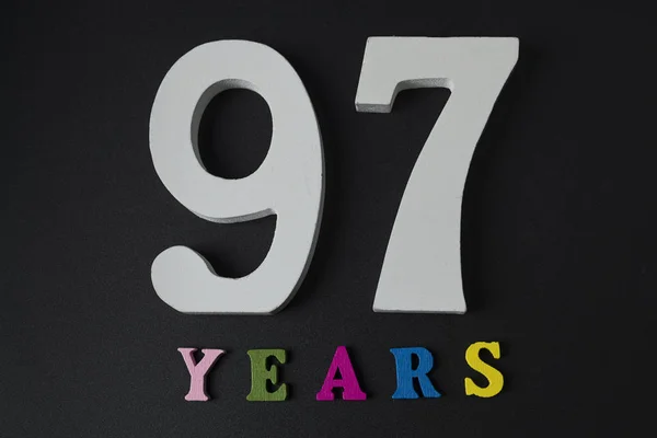 Lettere e numeri novantasette anni su sfondo nero . — Foto Stock