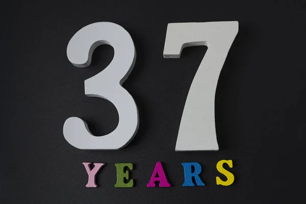 Letters and numbers thirty-seven years on a black background. — Stock Photo, Image