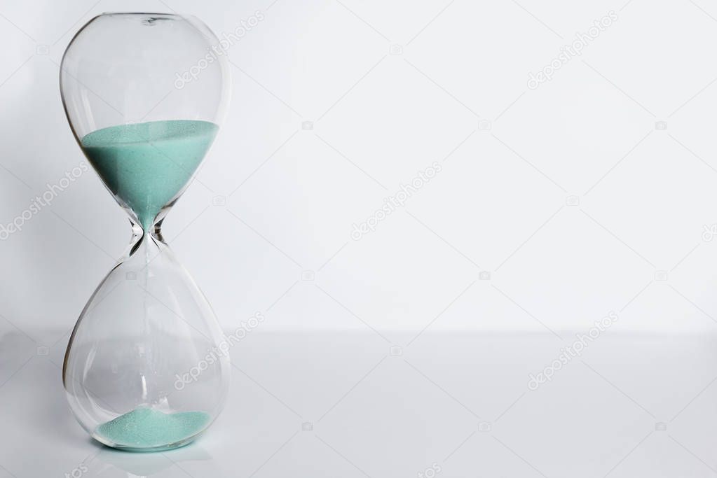 Old hourglass on white background.