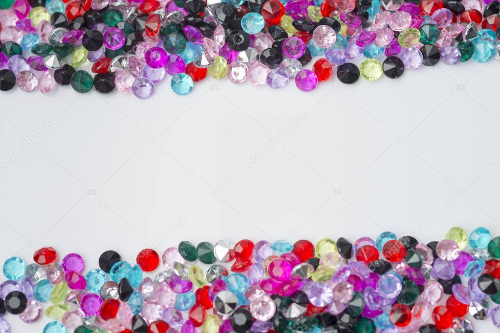 Colored decorative stones on a white background.