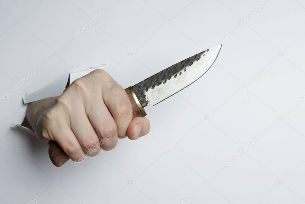 Female hand holding a knife on white background.