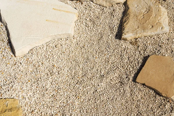 Pequeño muro de grava y arena, fondo de textura grunge, baldosas de piedra de guijarros fondo sin costuras . — Foto de Stock