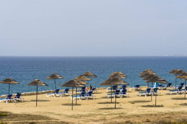 Plaj şezlong ve şemsiye turkuaz su bakan