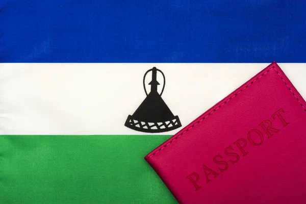 Sullo sfondo della bandiera di Lesotho è un passaporto . — Foto Stock