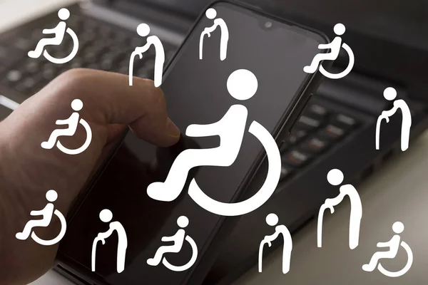 Disabled icons on the computer background. Assistance to the disabled. Concept of development of the system in helping disabled people with the help of a computer.