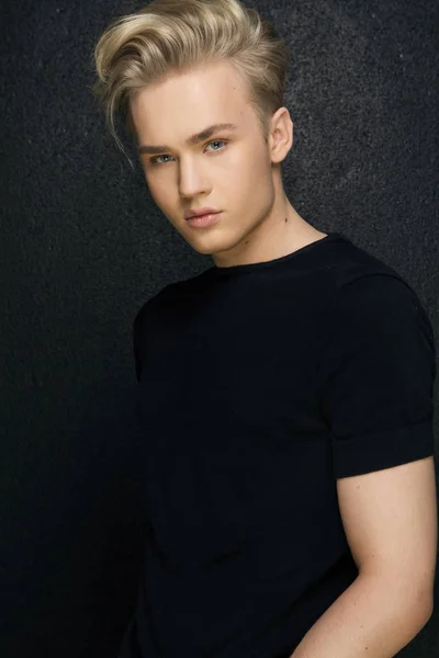 Attractive young guy posing in studio, blond hair looking at the — Stock Photo, Image
