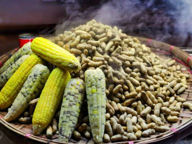 Steaming hot peanuts and corn on the cob in a market in Yangon, Myanmar. 