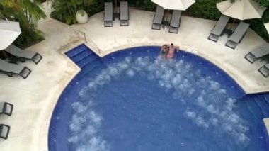 aerial drone couple in resort hot tub tropical beach vacation