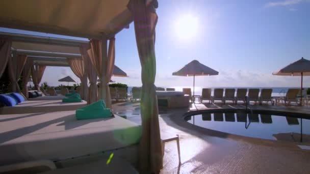Perfect Sunset Infinity Pool Umbrellas Slow Motion Trackin Shot — Stockvideo
