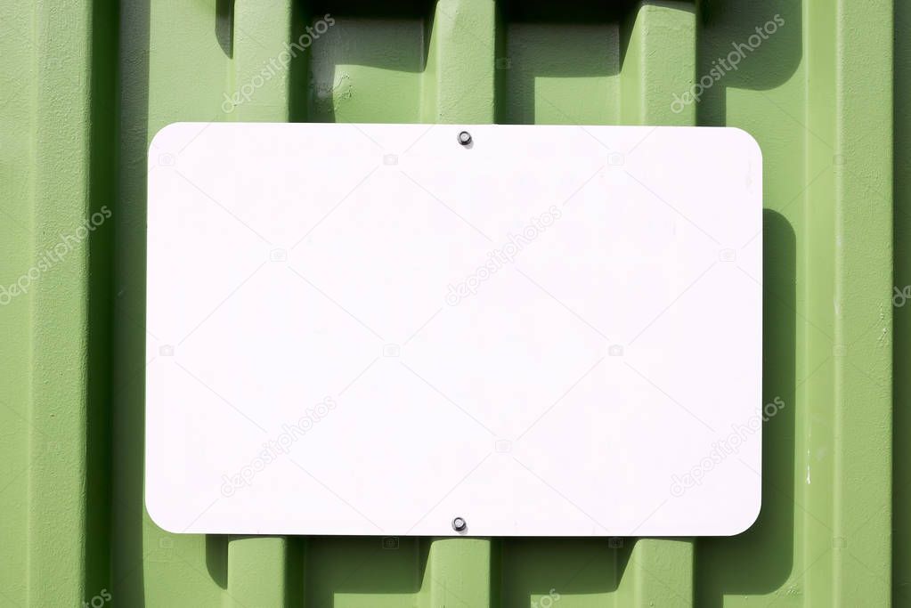 Metal Blank Sign on a Green Container