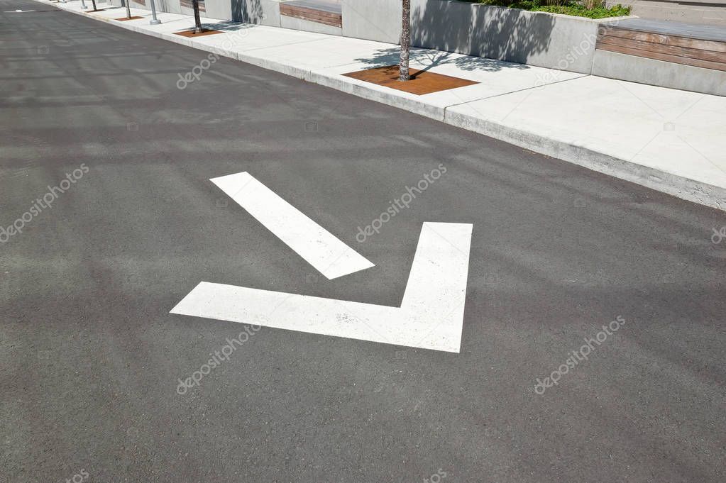 Driveway arrow on the ground shows direction of one way street.