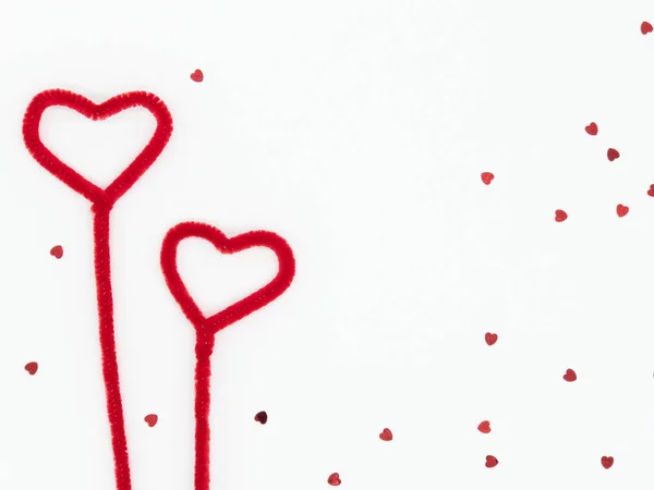 Zwei flauschige rote Herzen mit verstreutem Herzglitzern auf weißem Rücken — Stockfoto
