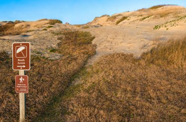 Beach Path and Sign:  A park sign directs hikers across the sand dunes at Cape Hatteras National Seashore.