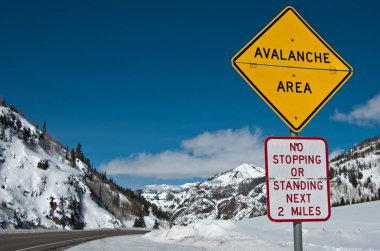 Avalanche Area Sign:  A convertible sign alerts winter travelers to possible snow slides in the Rocky Mountains of southwest Colorado. 