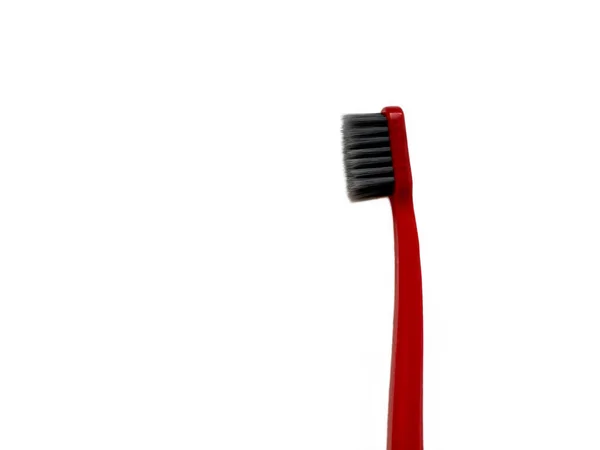 One red toothbrush on a white background — Stock Photo, Image