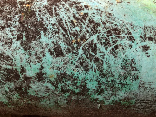 Soyut yüzey çizimi. Renkli duvar tasarımı. Eski asfaltta kurumuş, çatlamış, pürüzlü bir boya parçası. Soyut bir şekilde duvardaki duvar yazısını boyayarak..