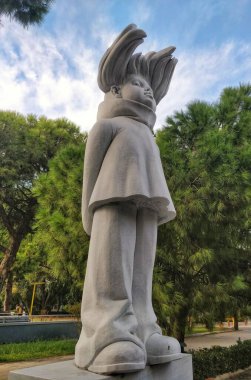 Modern feminist sculpture, young brave girl, hair blowing in wind
