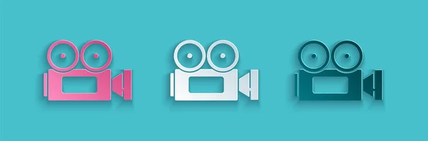 Papiergeschnittenes Kinokamera-Symbol isoliert auf blauem Hintergrund. Videokamera. Filmschild. Filmprojektor. Papierkunst. Vektorillustration — Stockvektor