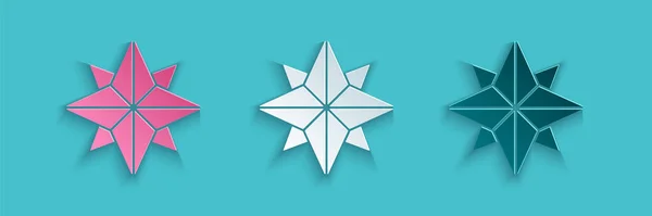 Papiergeschnittene Windrose Ikone isoliert auf blauem Hintergrund. Kompass-Symbol für Reisen. Navigationsdesign. Papierkunst. Vektorillustration — Stockvektor