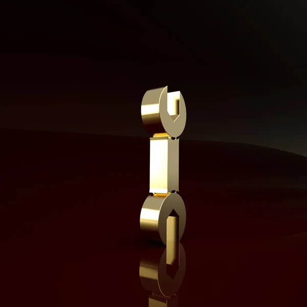 Значок гаечного ключа золотого цвета изолирован на коричневом фоне. Концепция минимализма. 3D-рендеринг — стоковое фото