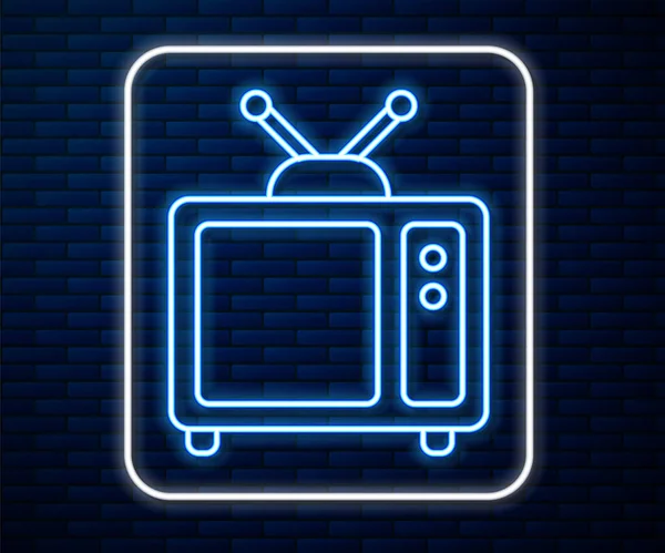 Brillante línea de neón Retro tv icono aislado en el fondo de la pared de ladrillo. Señal de televisión. Ilustración vectorial — Archivo Imágenes Vectoriales