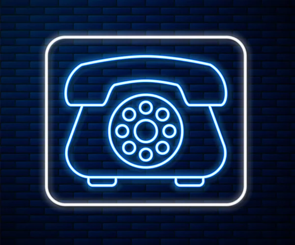Línea de neón brillante Icono de teléfono aislado en el fondo de la pared de ladrillo. Teléfono fijo. Ilustración vectorial — Archivo Imágenes Vectoriales
