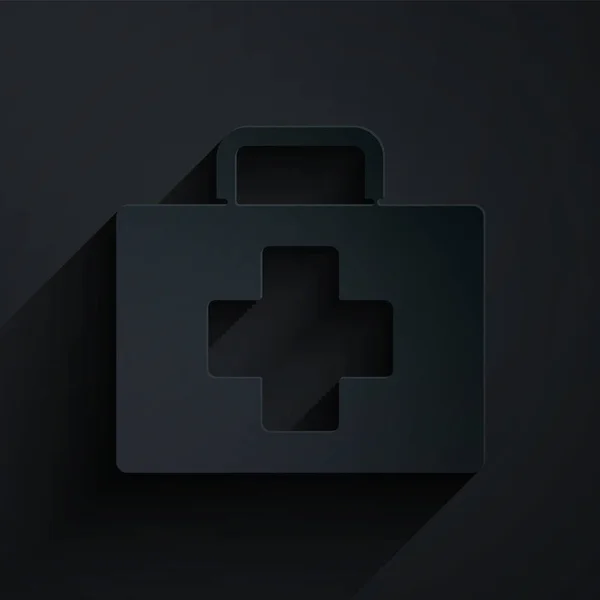 Paper cut First aid kit icon isolated on black background. Medical box with cross. Medical equipment for emergency. Healthcare concept. Paper art style. Vector Illustration