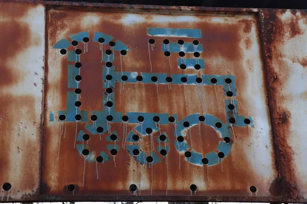 drawing of a train on a rusty piece of metal