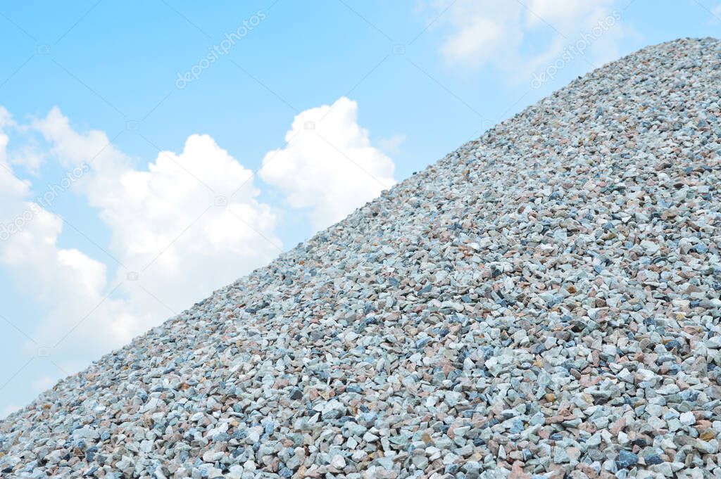 Hill of coarse aggregate with the blue sky. rock for construction