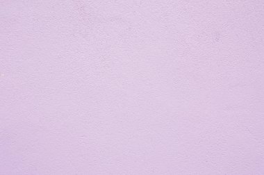 Beton duvar dokusunda yumuşak pembe pastel boya