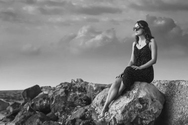 a girl walking at the beach black and white at the beach